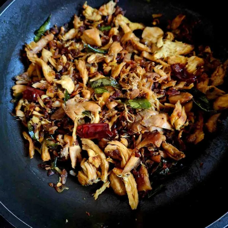 Indian-style shredded chicken fry cooked with spices, green chillies, lemon juice, and curry leaves until crispy.